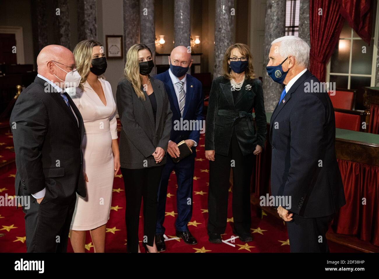 From right: Vice President Mike Pence, Former Congresswoman Gabby Giffords, Senator elect Mark Kelly, Mark Kelly's daughters Claudia Kelly and Claire Kelly, and brother Scott Kelly, talk following a mock swearing in ceremony, in the Old Senate Chamber on Capitol Hill, in Washington, DC, Wednesday, December 2nd, 2020.Credit: Graeme Jennings/Pool via CNP | usage worldwide Stock Photo