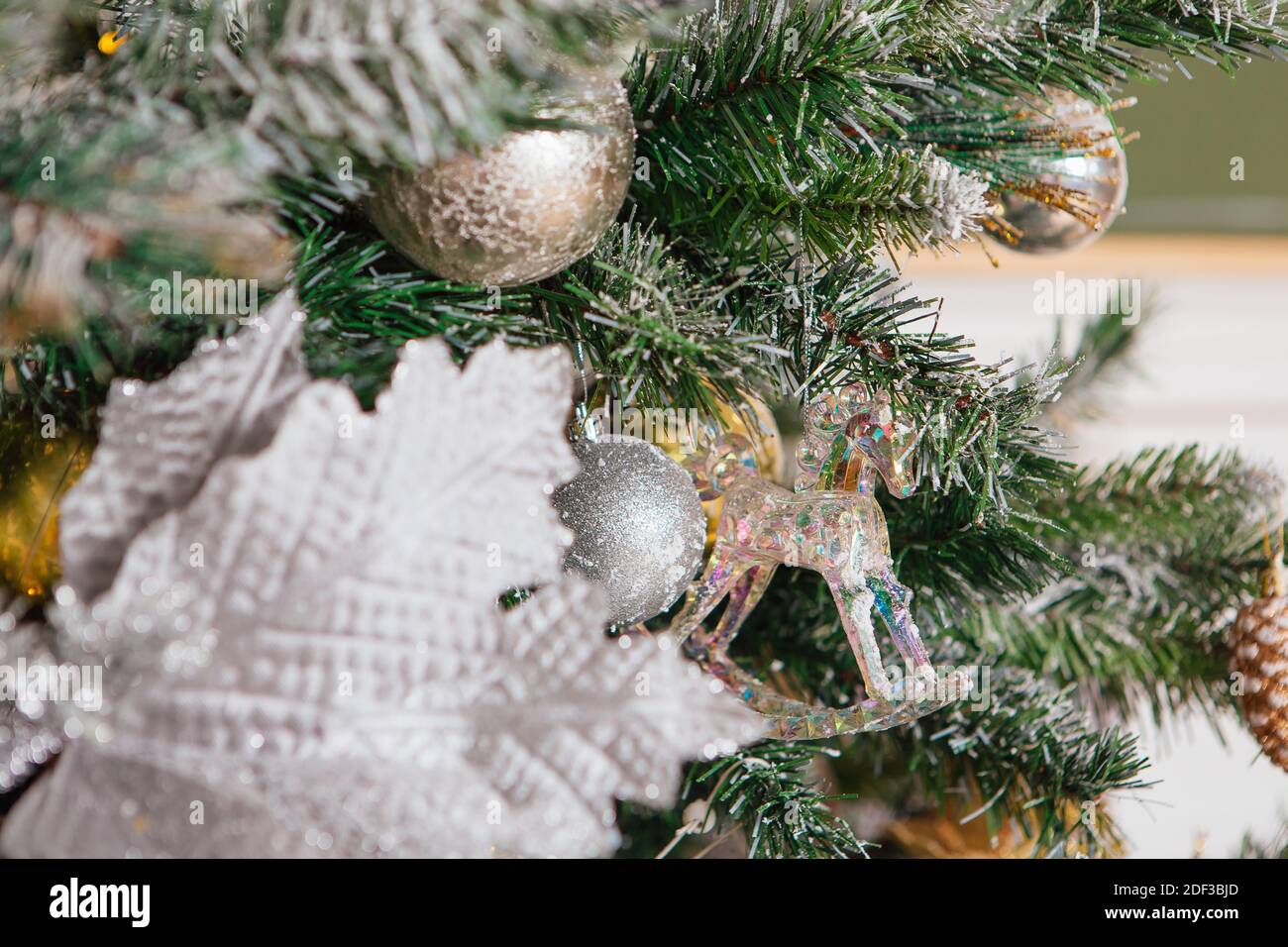 Christmas tree decorated with balls and other decorations close up ...