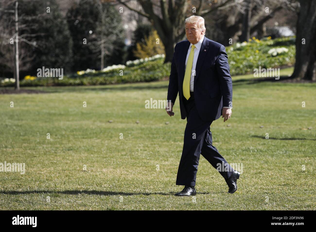 U.S. President Donald Trump walks on the South Lawn of the White House ...