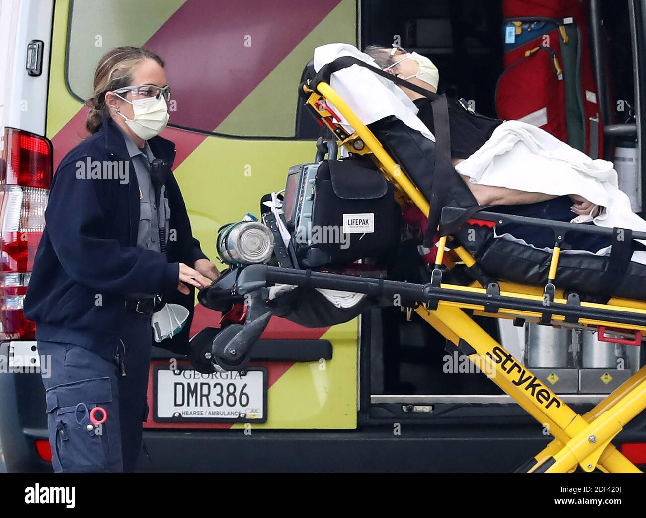 NO FILM, NO VIDEO, NO TV, NO DOCUMENTARY - An ambulance worker and a patient wear masks, indicating possible symptons of the cornavirus, arriving at the emergency entrance at WellStar Kennestone Hospital on Monday, March 16, 2020, in Marietta, Ga. Georgia authorities confirmed the stat's first coronavirus-related death at WellStar Kennestone Hospital last Thursday, saying the victim, who tested positive for the COVID-19 illness on March 7 also had 'underlying medical conditions.' Photo by Curtis Compton/Atlanta Journal-Constitution/TNS/ABACAPRESS.COM Stock Photo