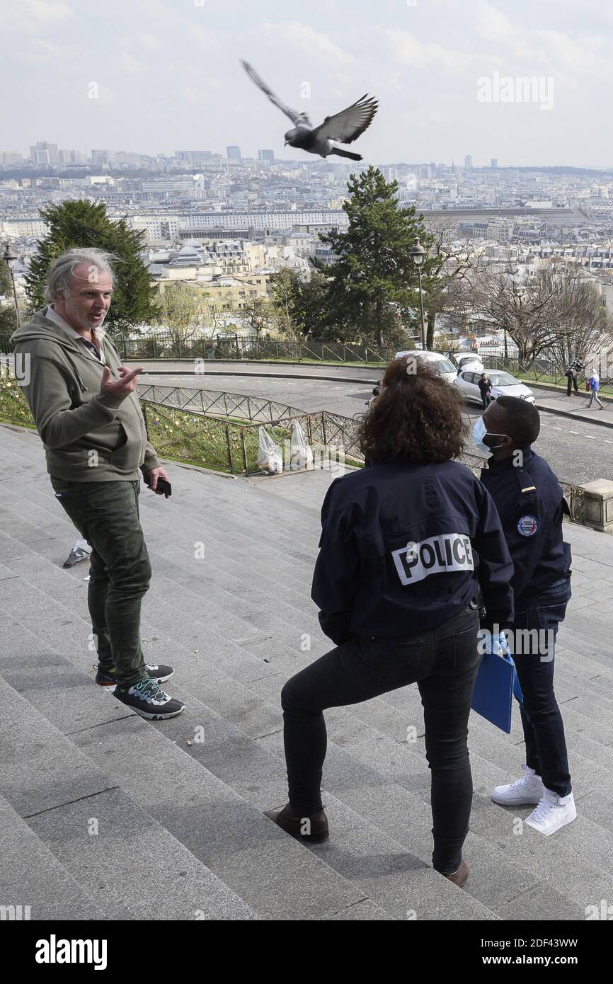 Paris Police Document A French police officer speaks with people are carrying the correct ...
