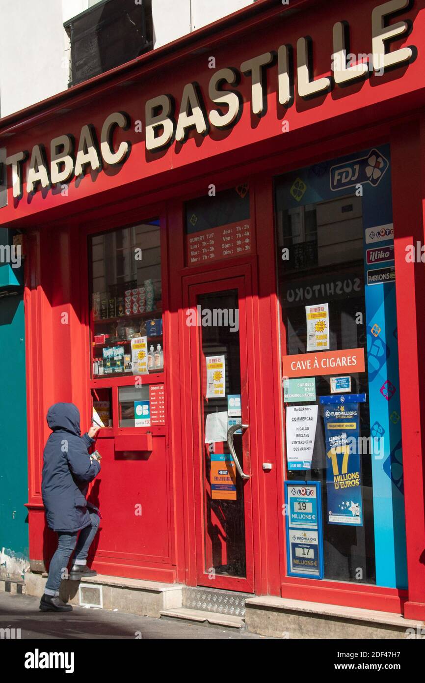 People are seen buying cigarettes in a tobacco shop during COVID-19 as a strict lockdown comes into effect to stop the spread of the Coronavirus disease. Shot in Paris, France on March 24, 2020. Photo by Aurore Marechal/ABACAPRESS.COM Stock Photo