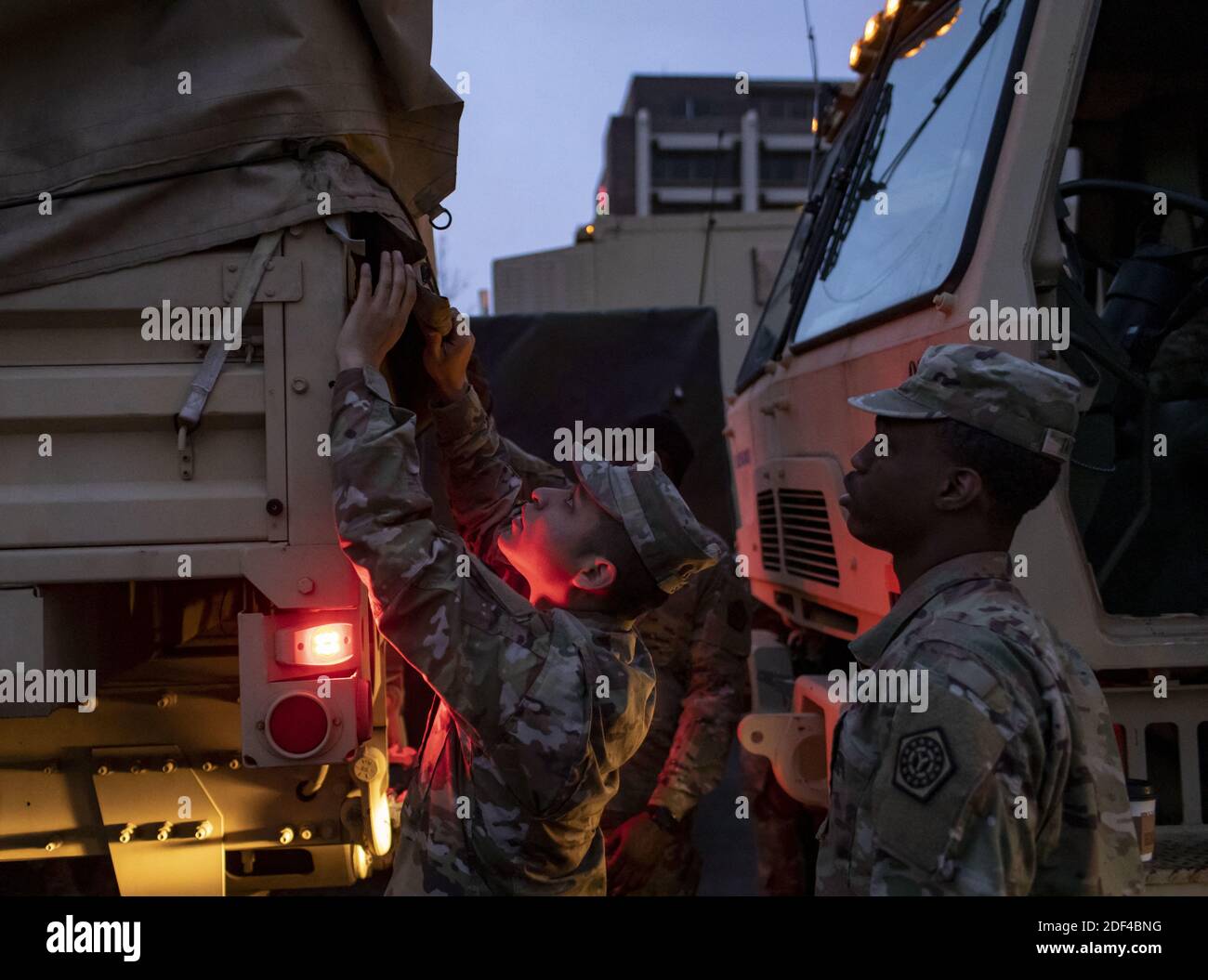 NO FILM, NO VIDEO, NO TV, NO DOCUMENTARY - Spc. Felipe Sosa (center) and other members of the Illinois National Guard perform vehicle checks on their convoy before sunrise Thursday, March 26, 2020 in the parking lot of Rivers Casino to begin the day's work. The Guard is running a coronavirus testing facility open to first responders on the Northwest Side. Photo by Brian Cassella/Chicago Tribune/TNS/ABACAPRESS.COM Stock Photo