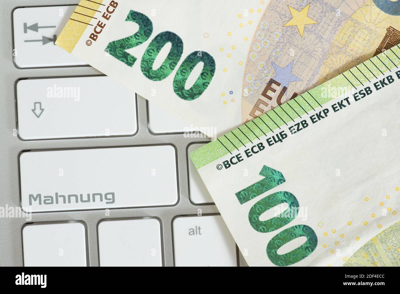 Euro money, computer and key for reminder Stock Photo