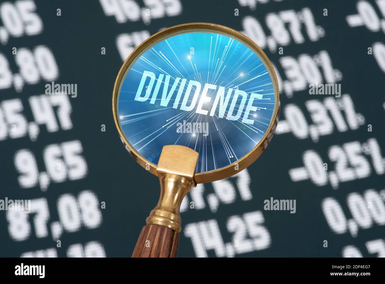 Price board on the stock market, magnifying glass and the dividend Stock Photo