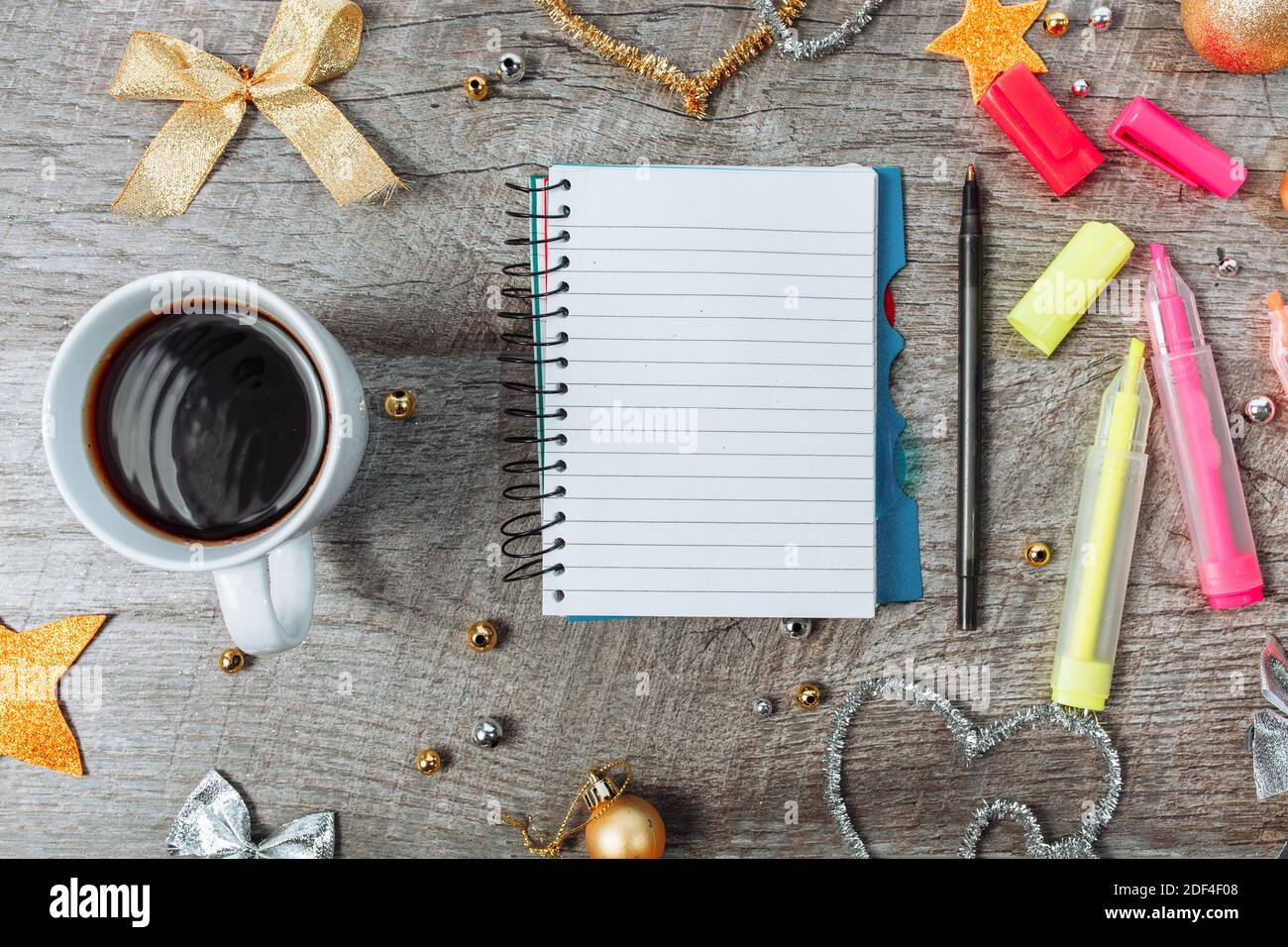 Christmas decoration with an open notebook and a cup of coffee, planning the new year. on wooden background. Stock Photo