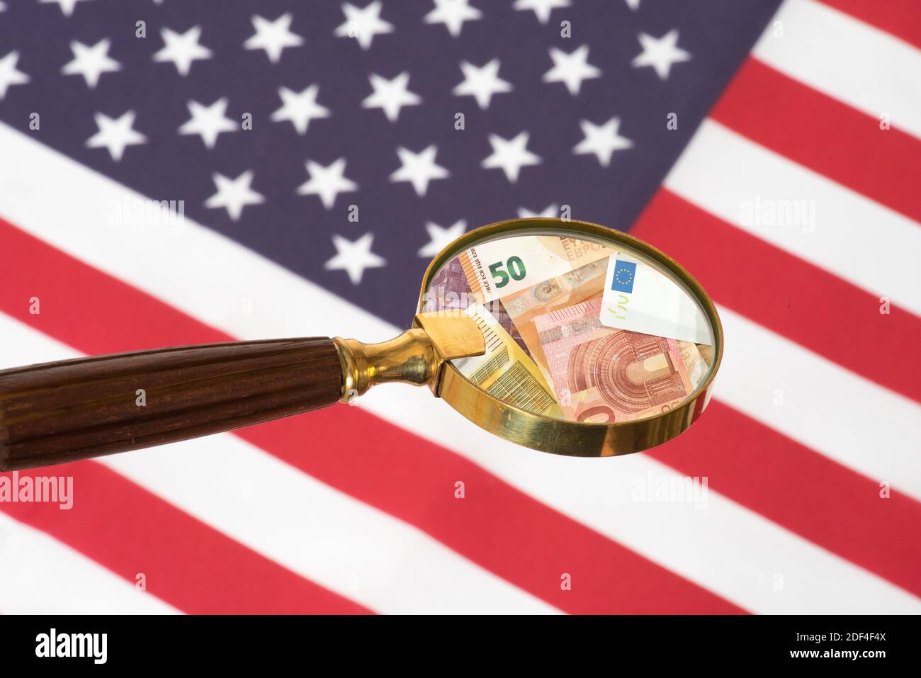 Flag of America, magnifying glass and euro banknotes Stock Photo