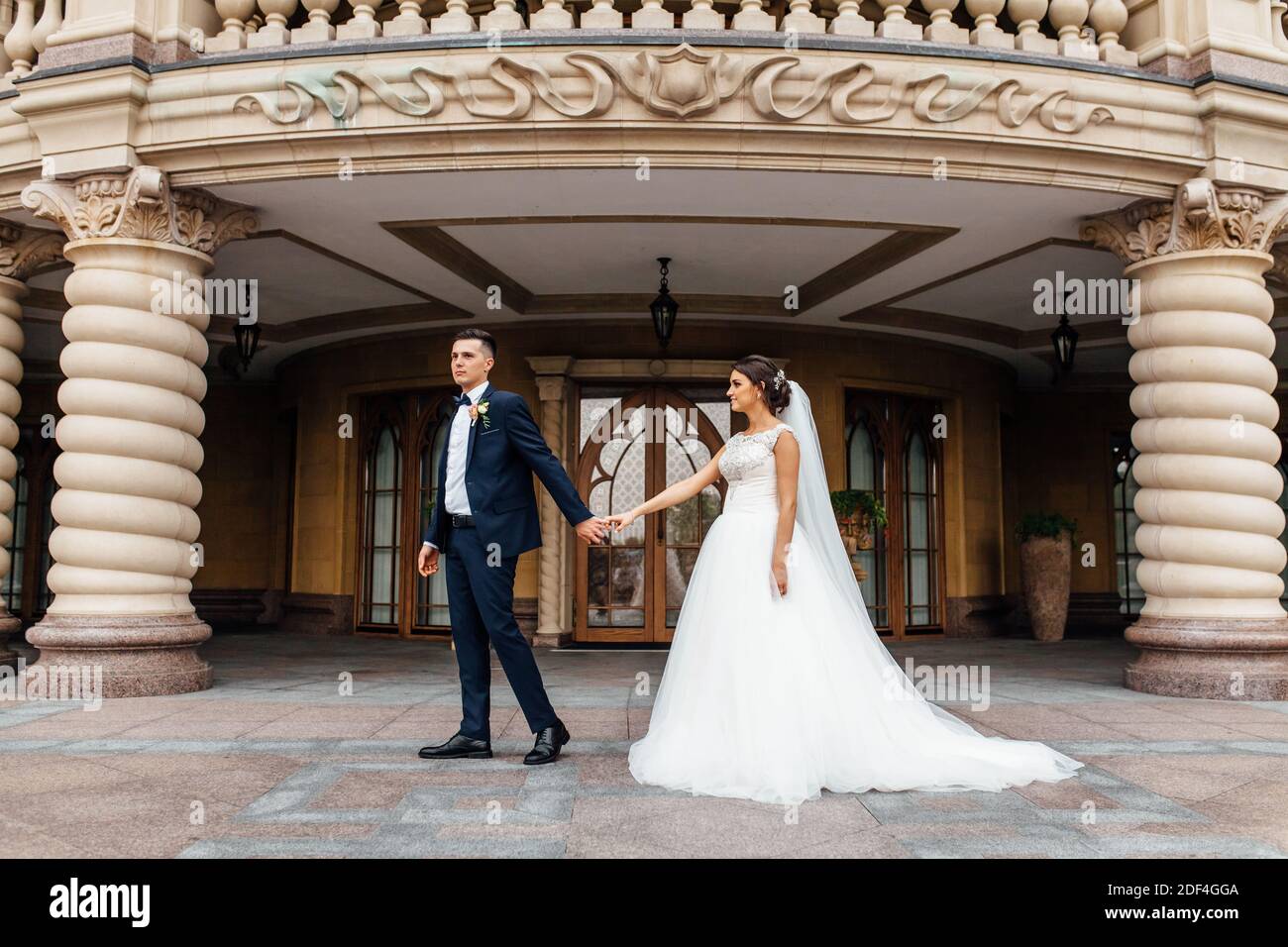 portrait of the bride and groom near the building Stock Photo - Alamy
