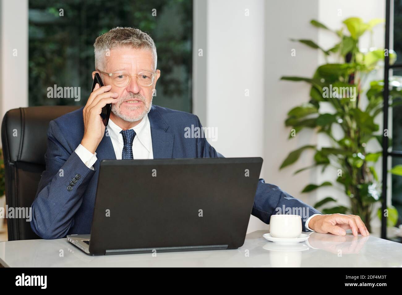 Angry entrepreneur talking on phone Stock Photo