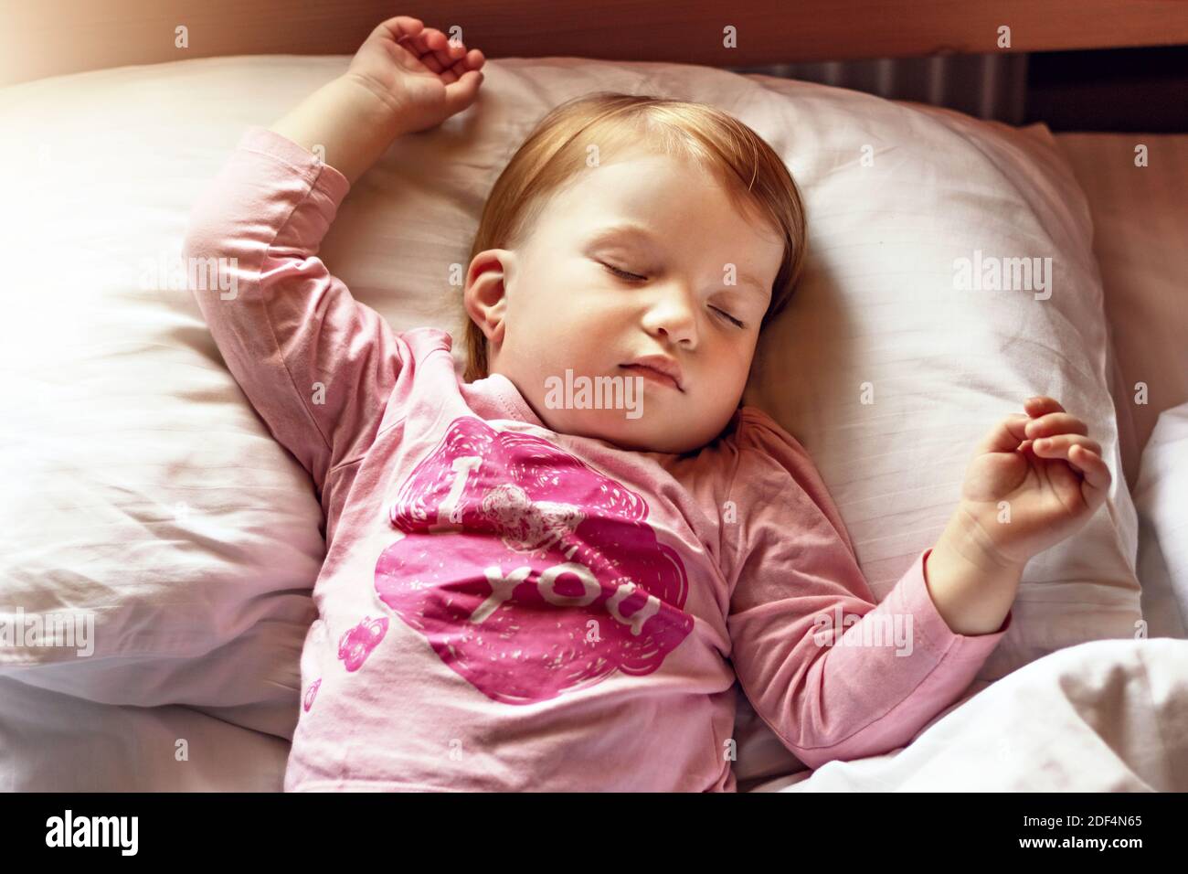Child little girl sleeping in bed. Morning time Stock Photo - Alamy