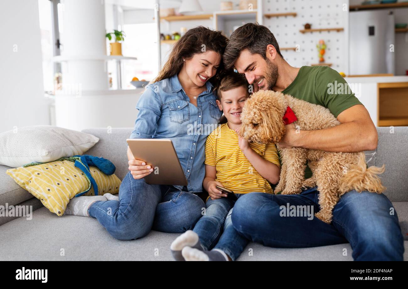 Happy modern family using computer together at home Stock Photo - Alamy