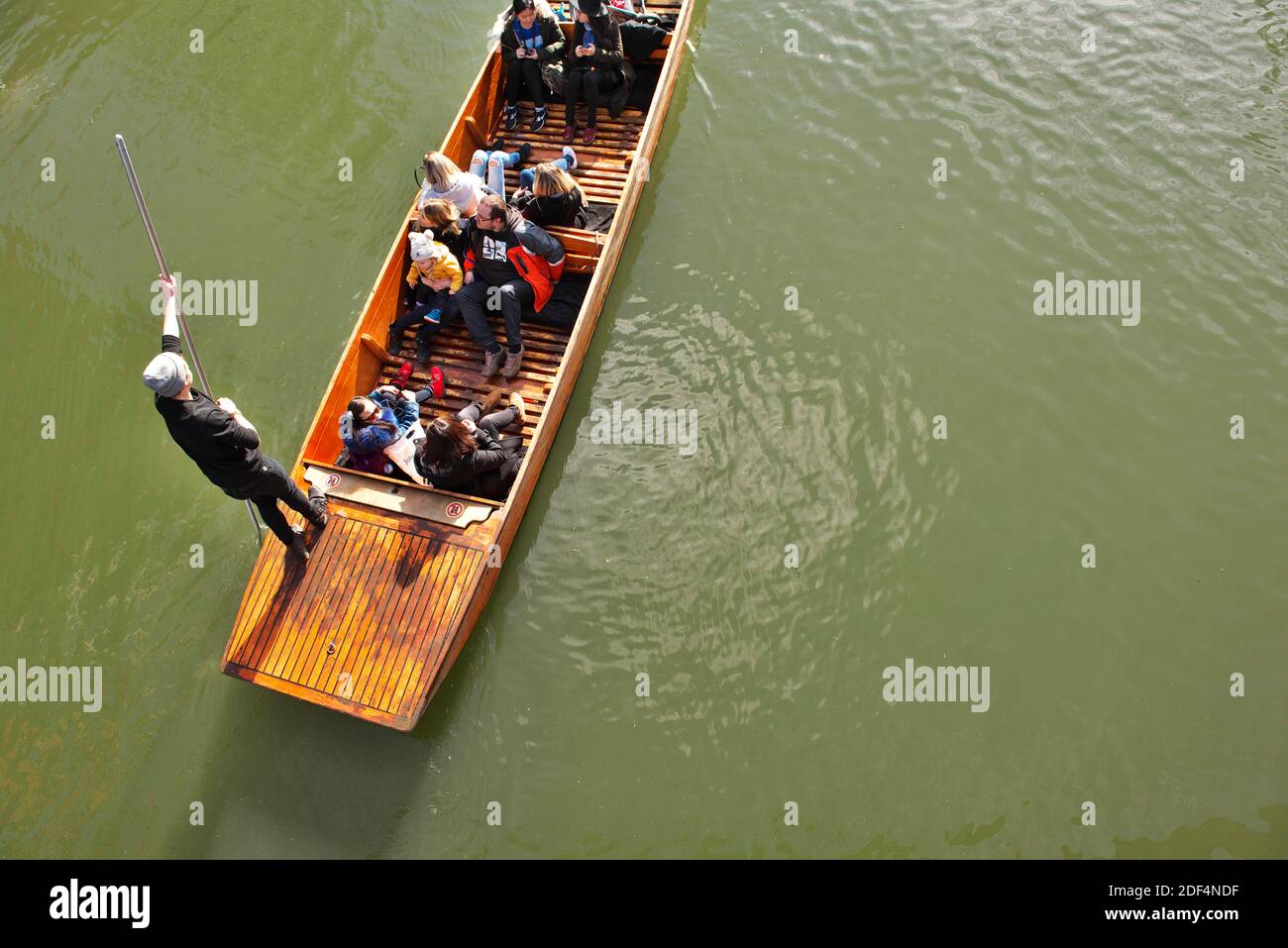 Looking down on a Punt on the River Cam, Cambridge, with tourists and punt guide Stock Photo
