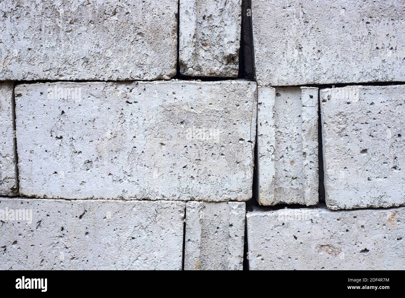 White concrete bricks closeup photo texture. Concrete block surface. Rough grey stone brick. Masonry wall made of big block. Rustic stone texture. Ind Stock Photo