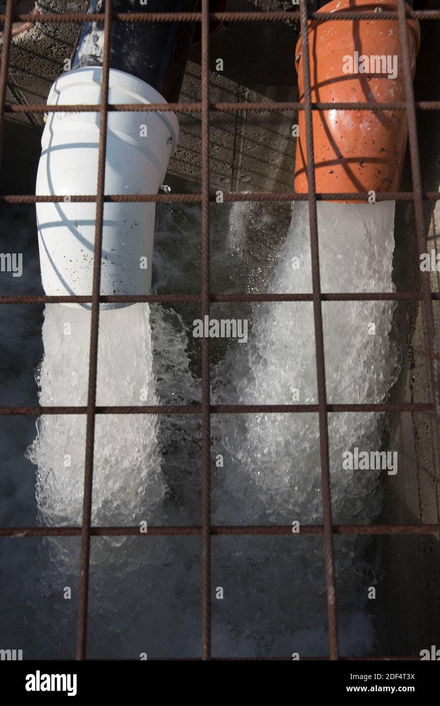 bubbling water flows from two big drain pipes, refreshing wet Stock Photo Alamy