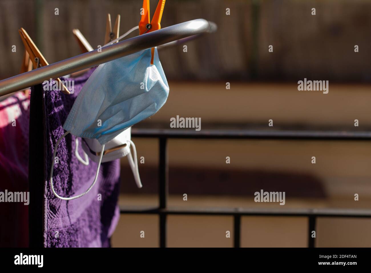 Two COVID19 masks hanging on the portable drying rack for ventilation