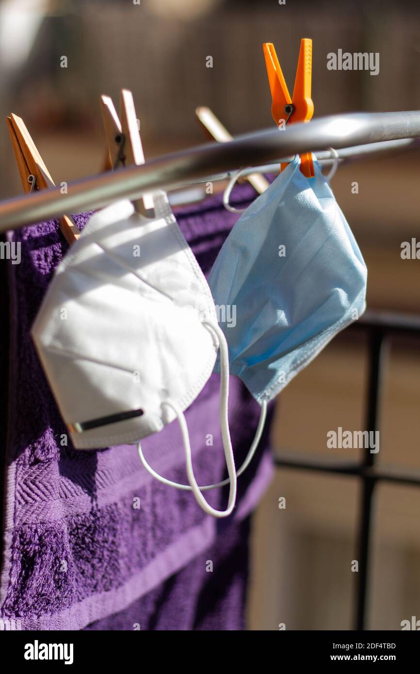 Two COVID19 masks hanging on the portable drying rack for ventilation