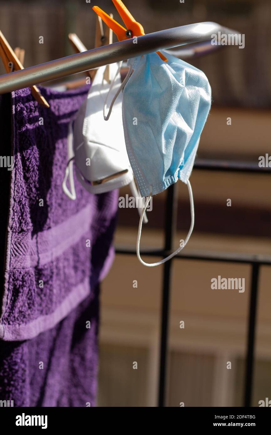 Two COVID19 masks hanging on the portable drying rack for ventilation