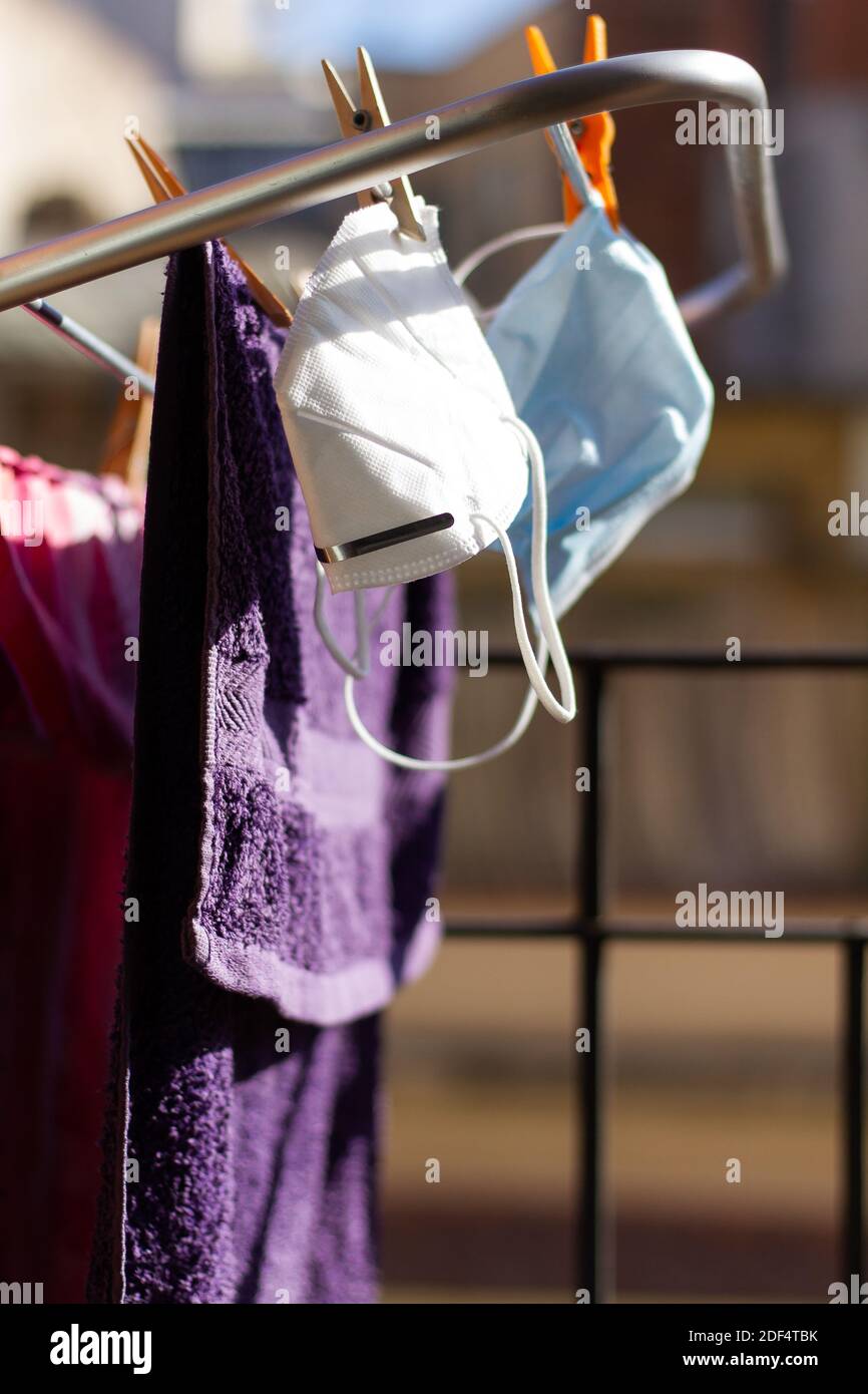 Two COVID19 masks hanging on the portable drying rack for ventilation