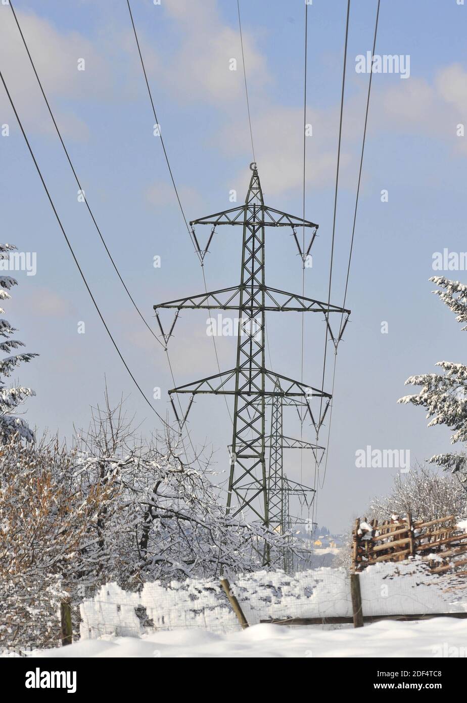High voltage line in the alps in winter, snowy landscape Stock Photo ...