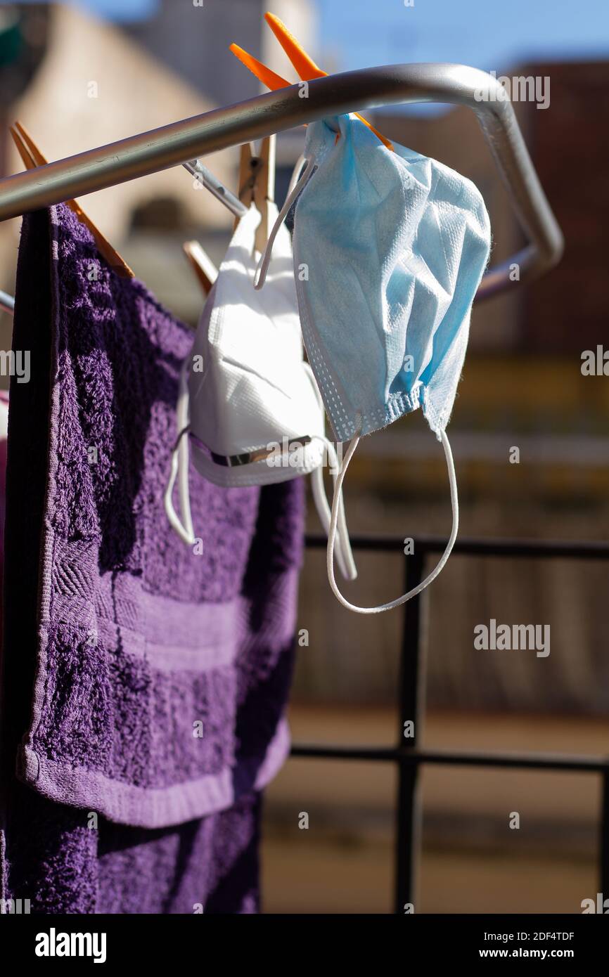 Two COVID19 masks hanging on the portable drying rack for ventilation