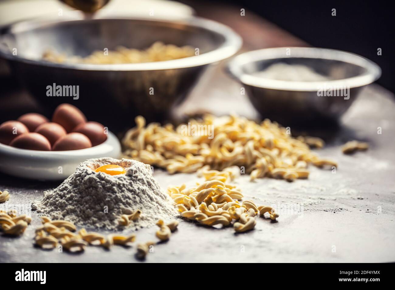 Ingredients for an Italian egg pasta including yolk, flour and bowls