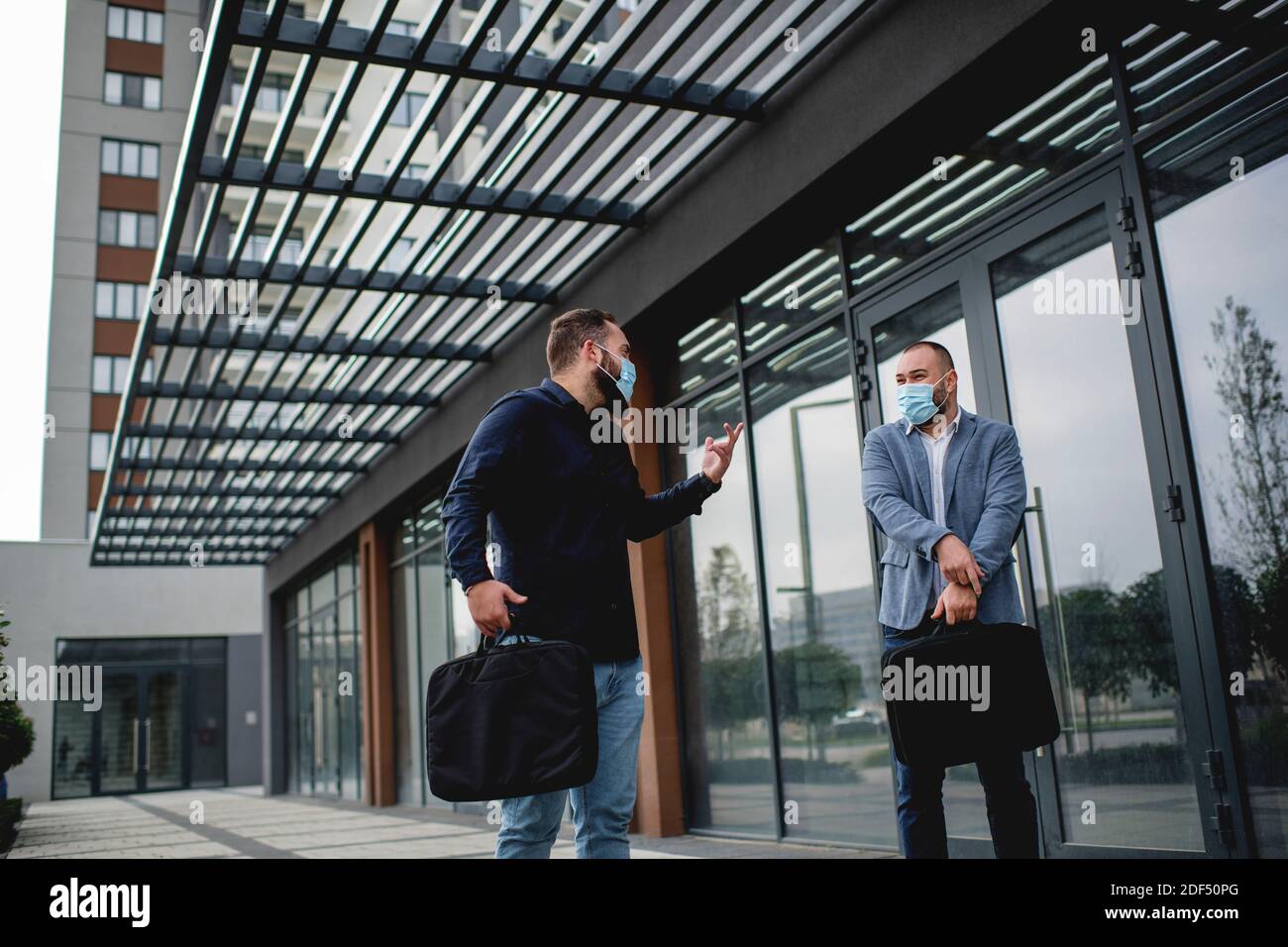 Two men wearing standing face hi-res stock photography and images - Alamy