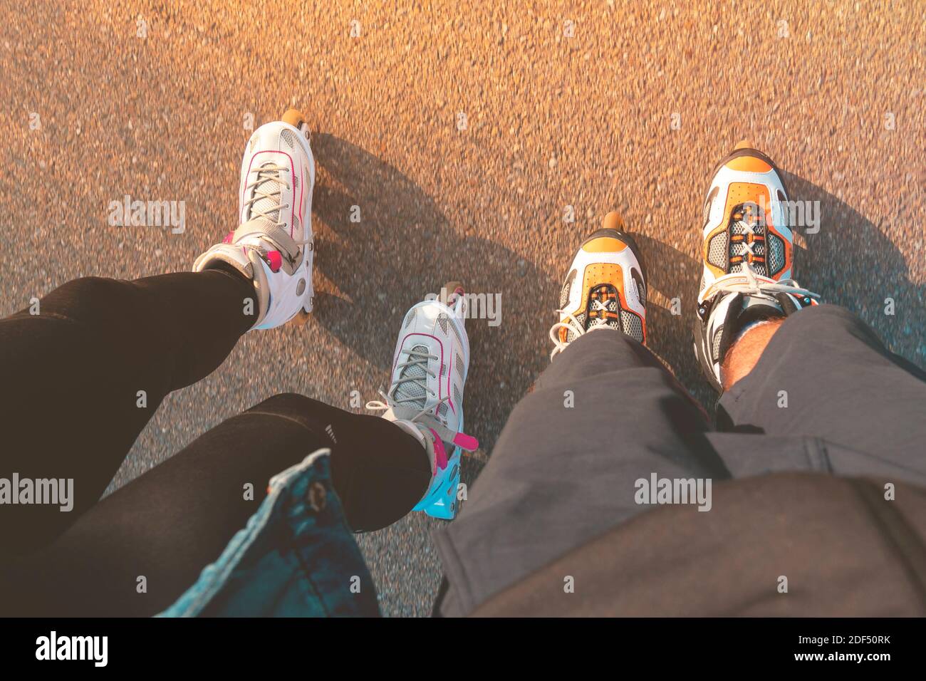 Top view of legs with inline skates. Boy and girl on roller skates. Place for text. Stock Photo