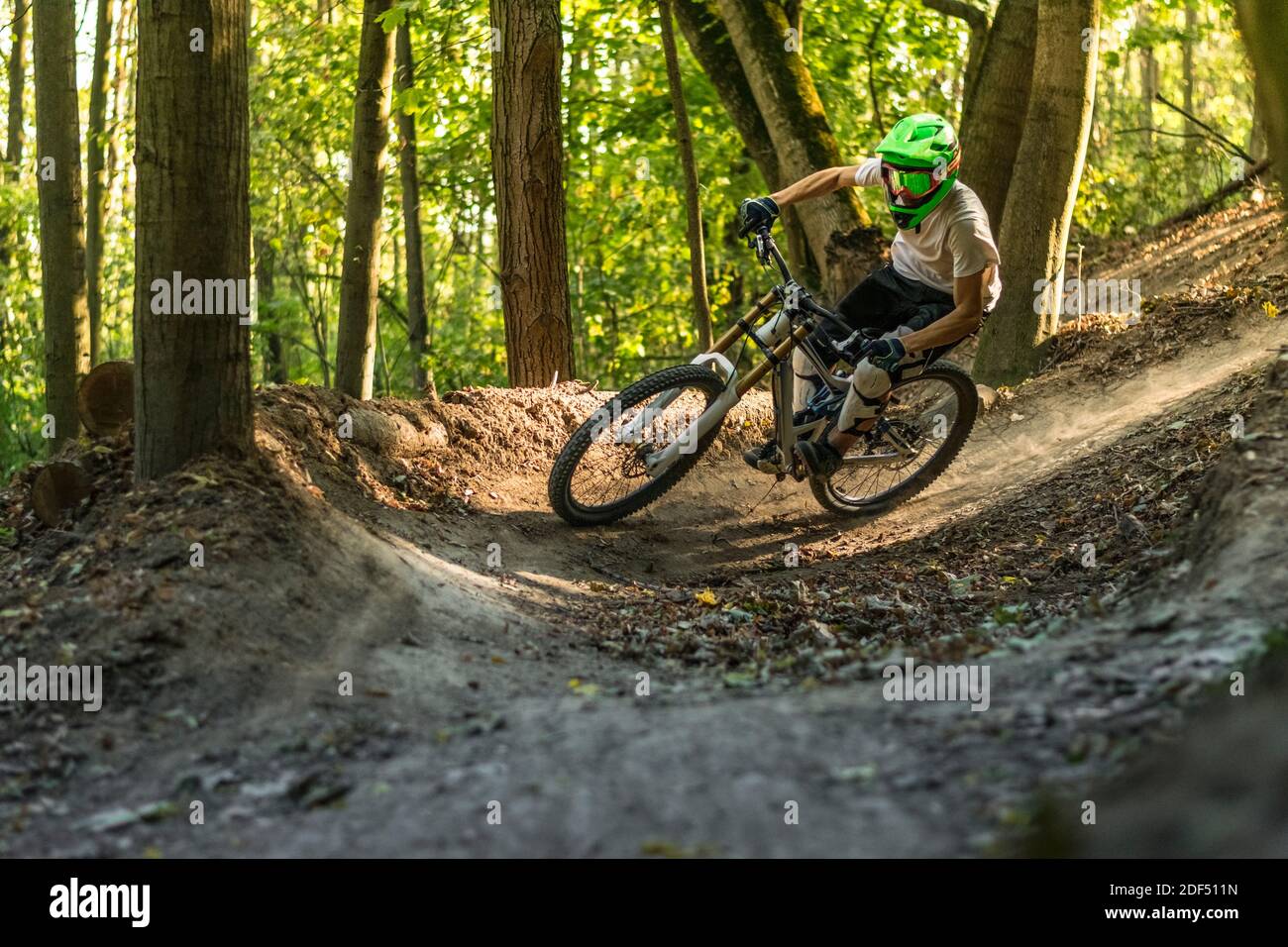 Downhill mountain biker in motion crossing trails. Stock Photo