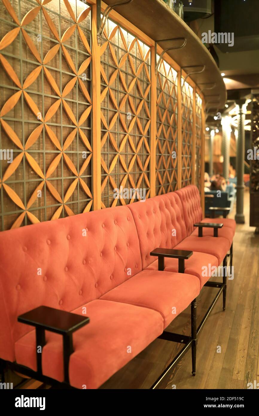 Sofa along wall in restaurant at night Stock Photo - Alamy
