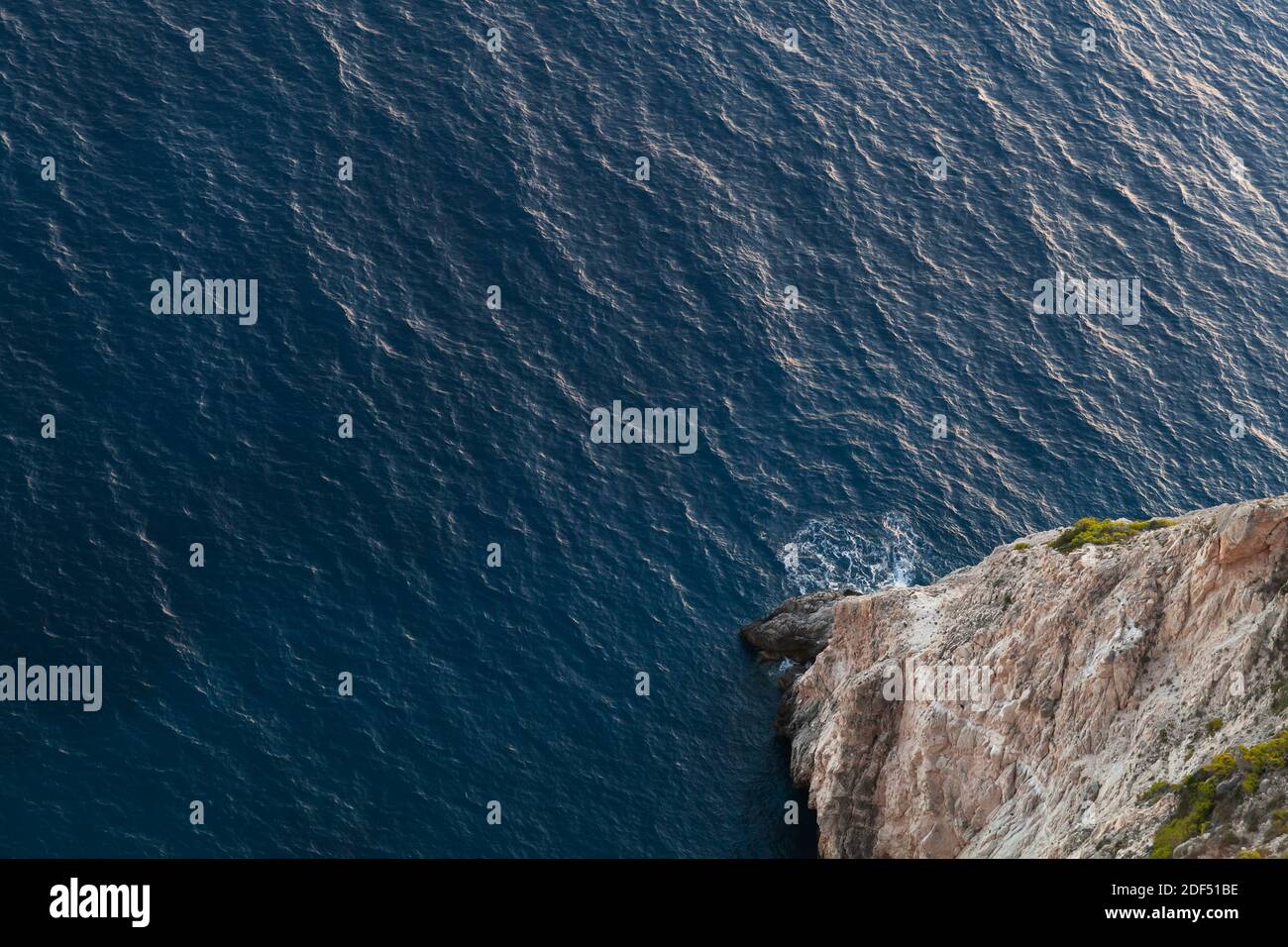 High cliff and sea water, top view. Rocky coast of Zakynthos island, Greece Stock Photo