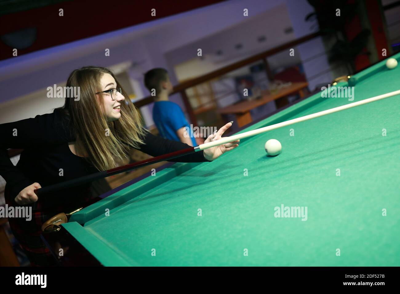 Portrait of teen playing billiards at night Stock Photo Alamy