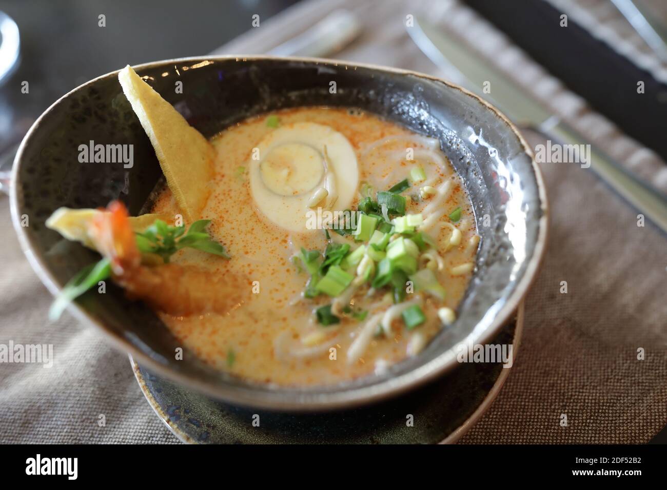 Bowl of seafood soup on table in restaurant Stock Photo