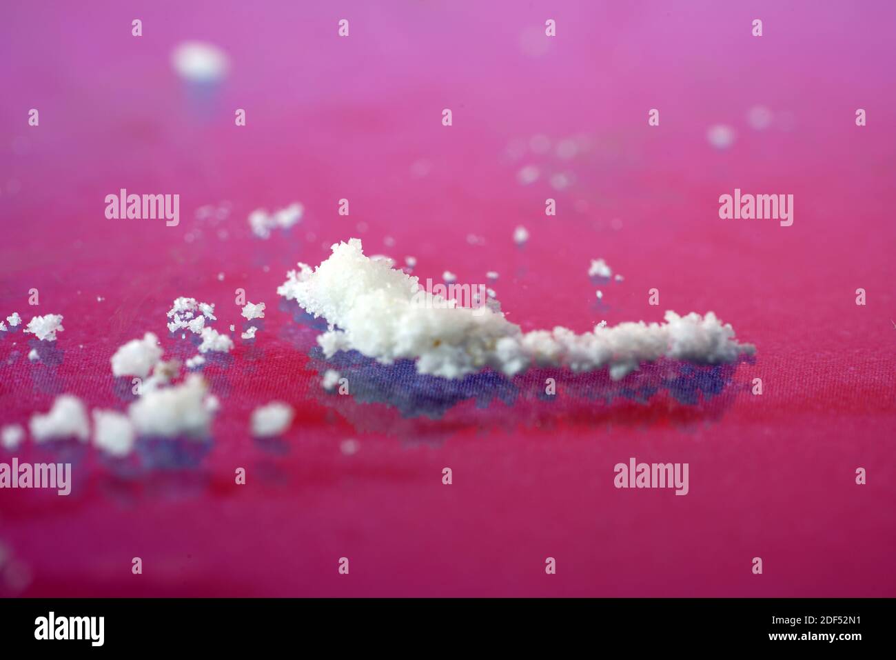 A selective focus closeup of powdered sugar on a pink background Stock Photo