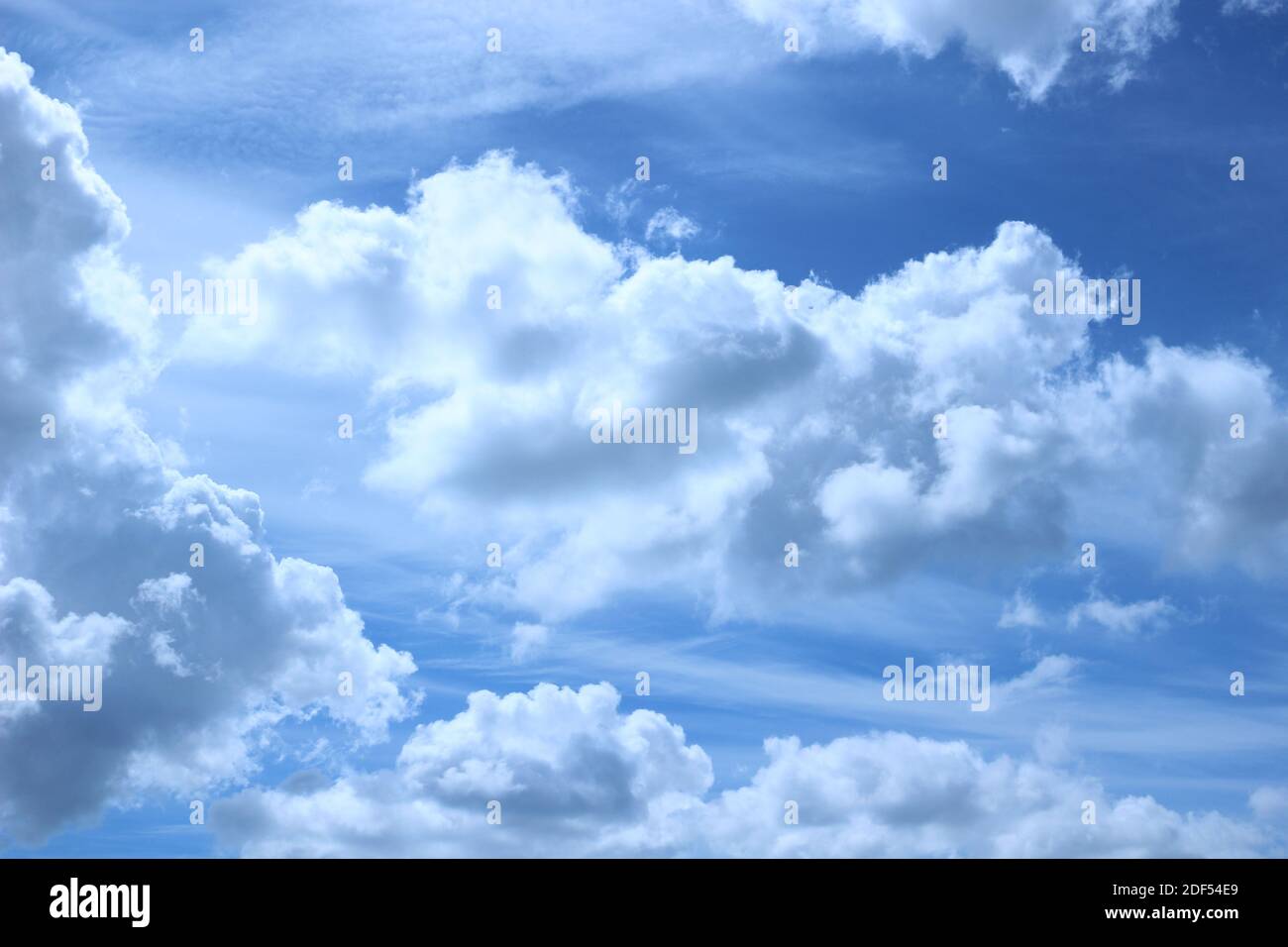 Clear blue sky with white fluffy clouds Stock Photo