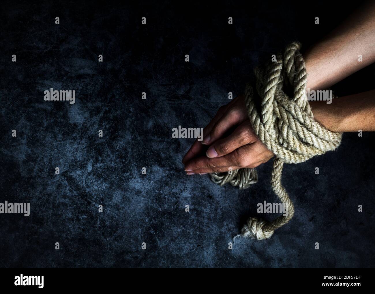 Tied hands of a woman Stock Photo