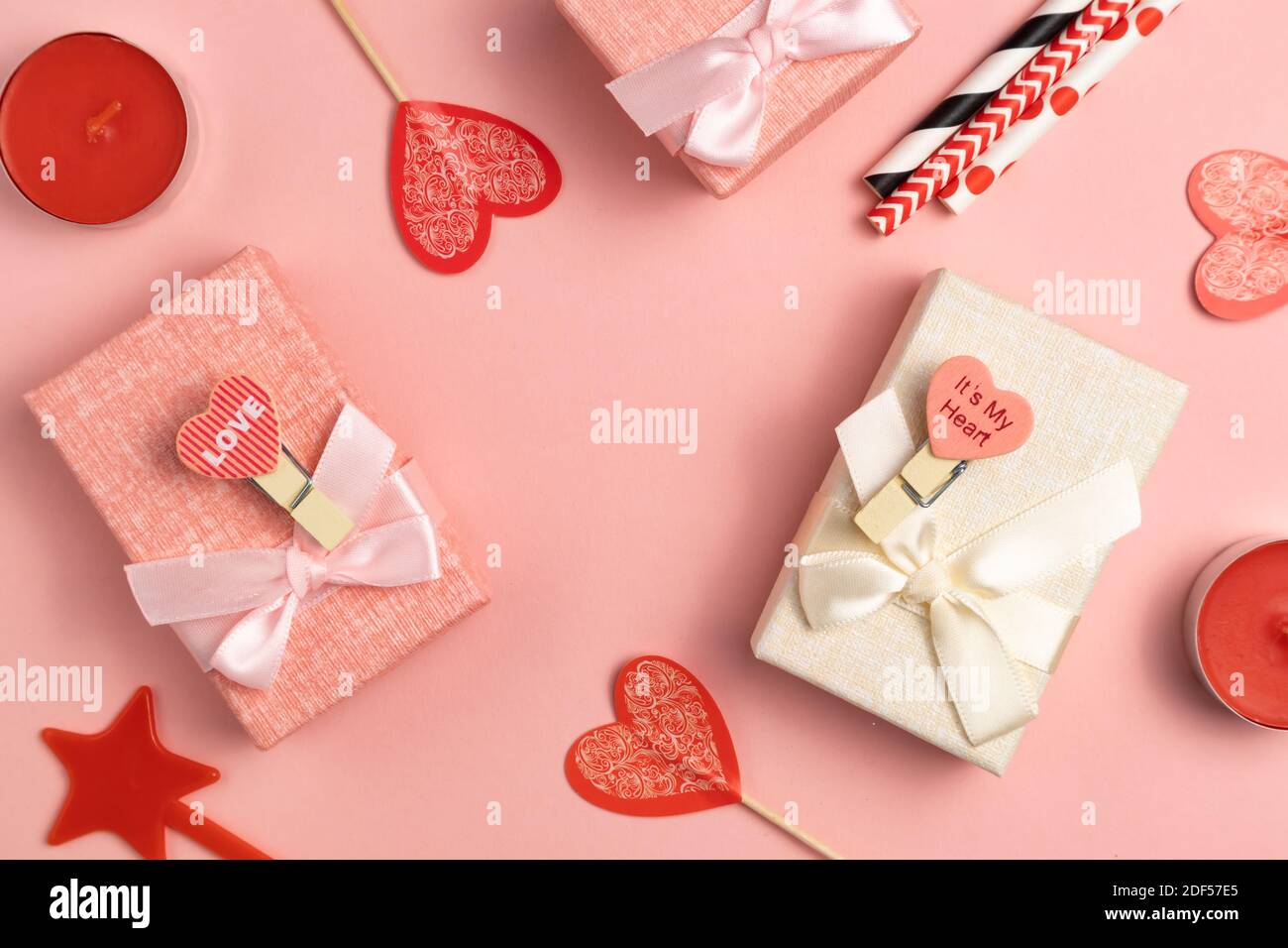 Boxes for small gifts in pastel colors on a pink background with place