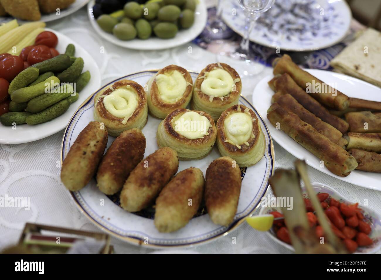 Plates with various appetizers on dinner table Stock Photo Alamy