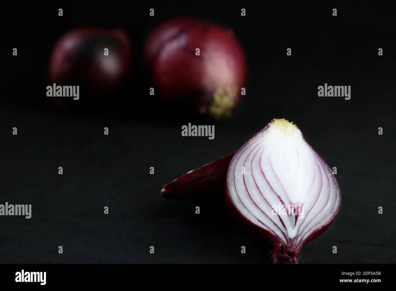 Red onions isolated on black background Stock Photo