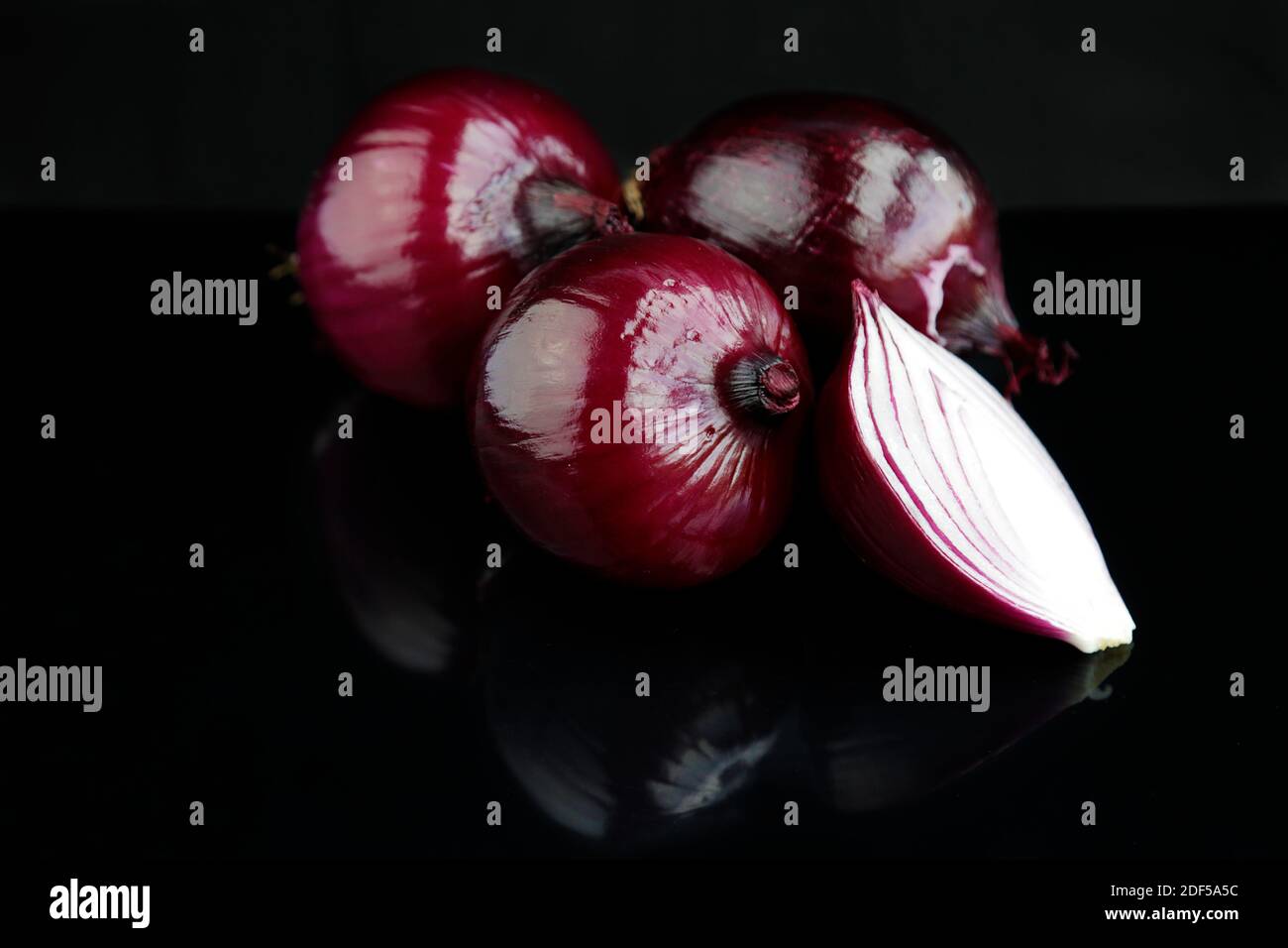Red onions isolated on black background Stock Photo