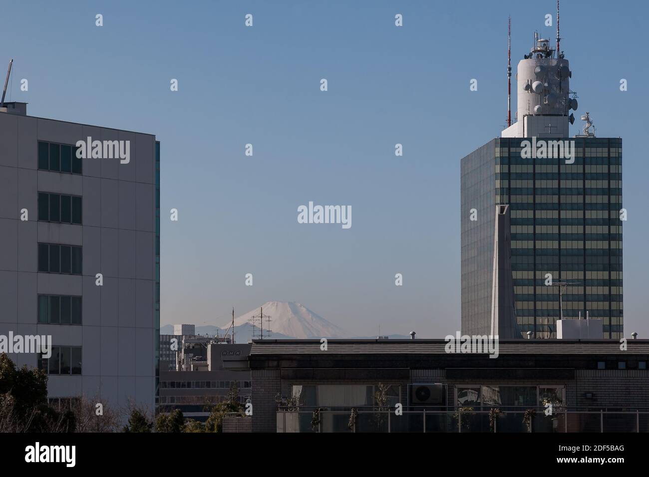 Mount Fuji seen behind the NHK Broadcasting  Center buildings in Shibuya, Tokyo, Japan. Stock Photo