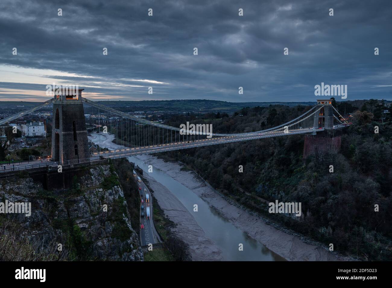Clifton Suspension Bridge at sunset, with light trails from the vehicles. Stock Photo