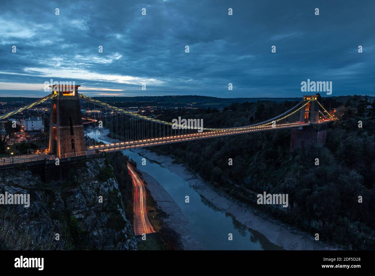 Clifton Suspension Bridge at sunset, with light trails from the vehicles. Stock Photo