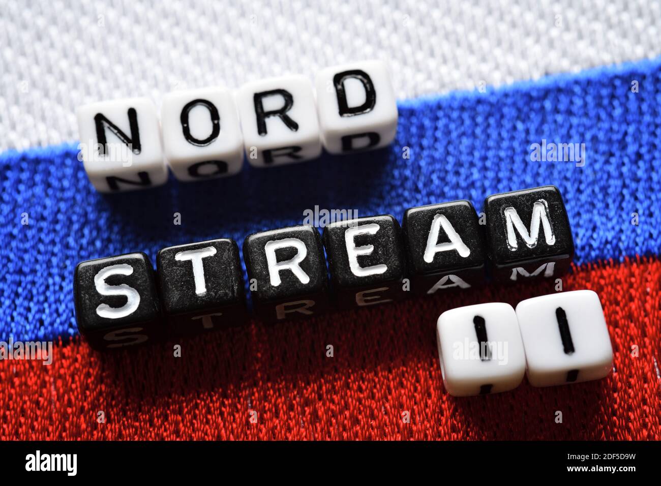 Letter Cubes Forming The Words Nord Stream 2 On The Flag Of Russia, Baltic Sea Gas Pipeline Stock Photo