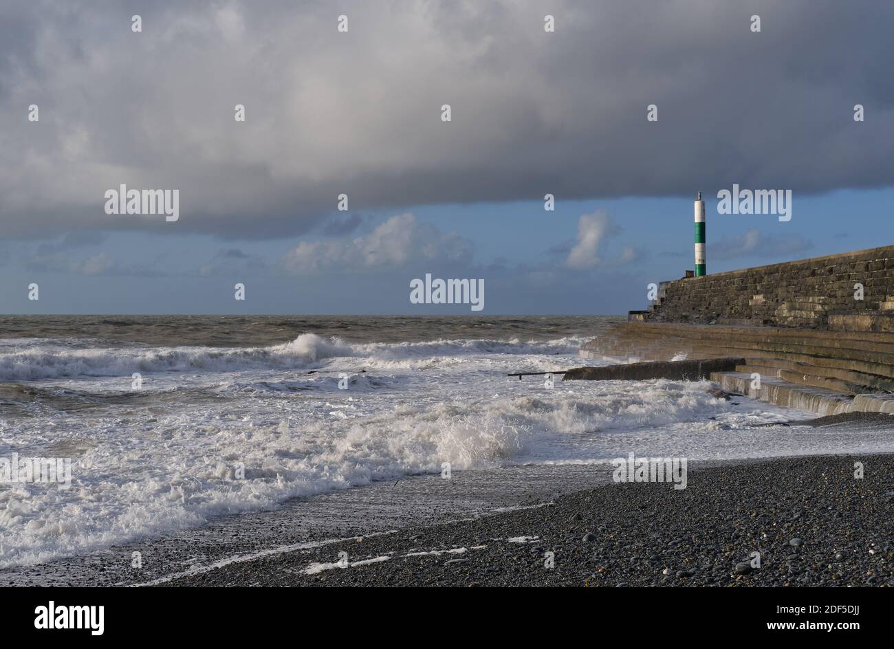 waves breaking on shore on a stormy day Stock Photo