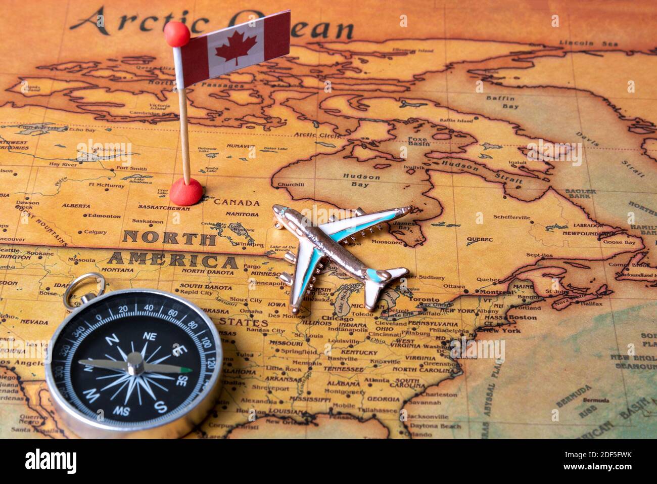 Canada flag, compass and airplane on the world map. The concept of travel and tourism Stock