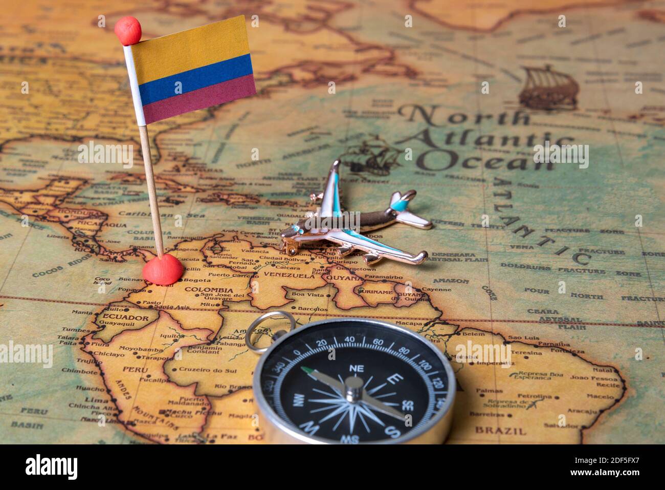 Flag of Colombia, compass and plane on the world map. The concept of travel  and tourism Stock Photo - Alamy