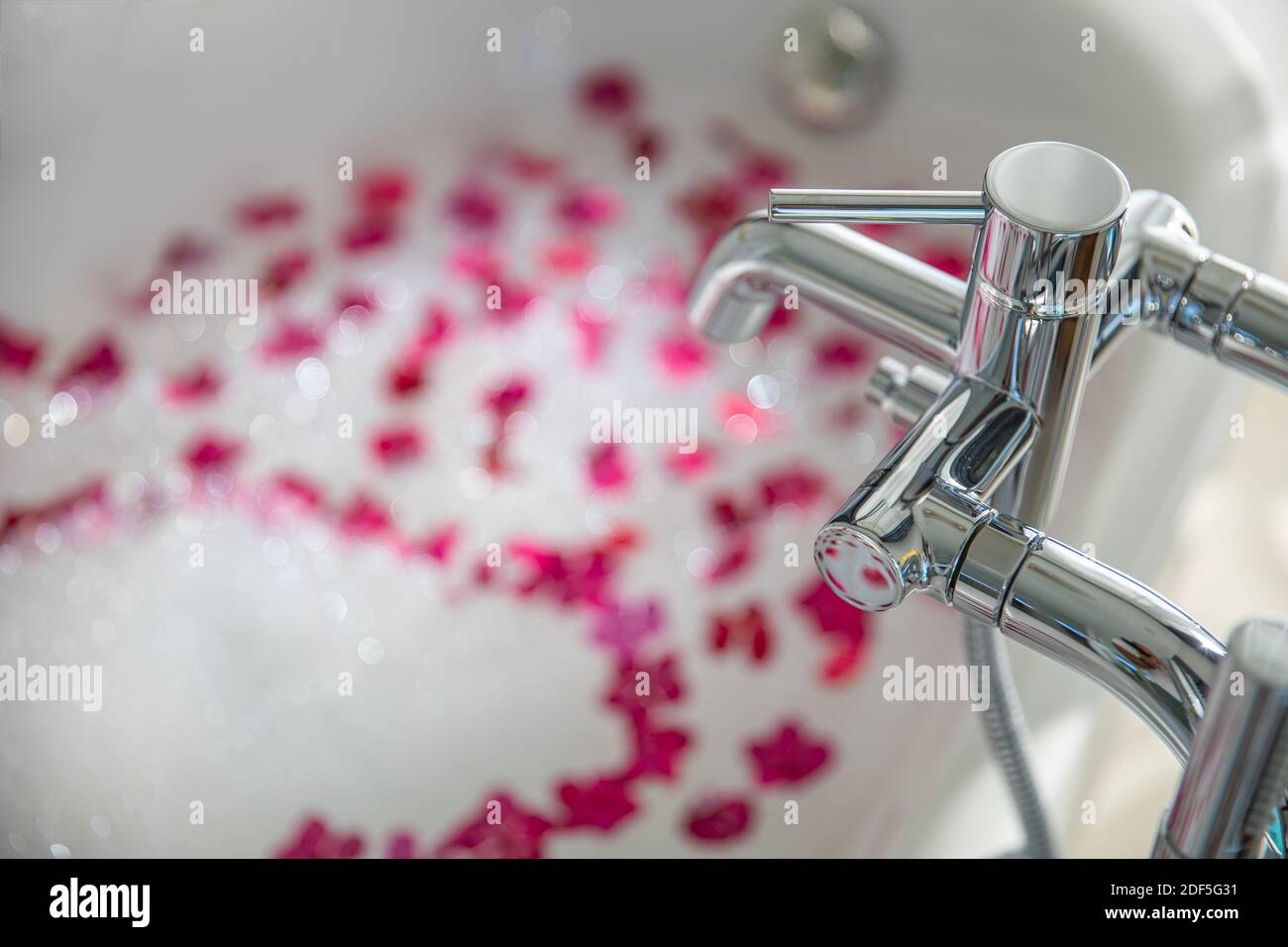 Rose petals put in bathtub for romantic bathroom in honeymoon suit