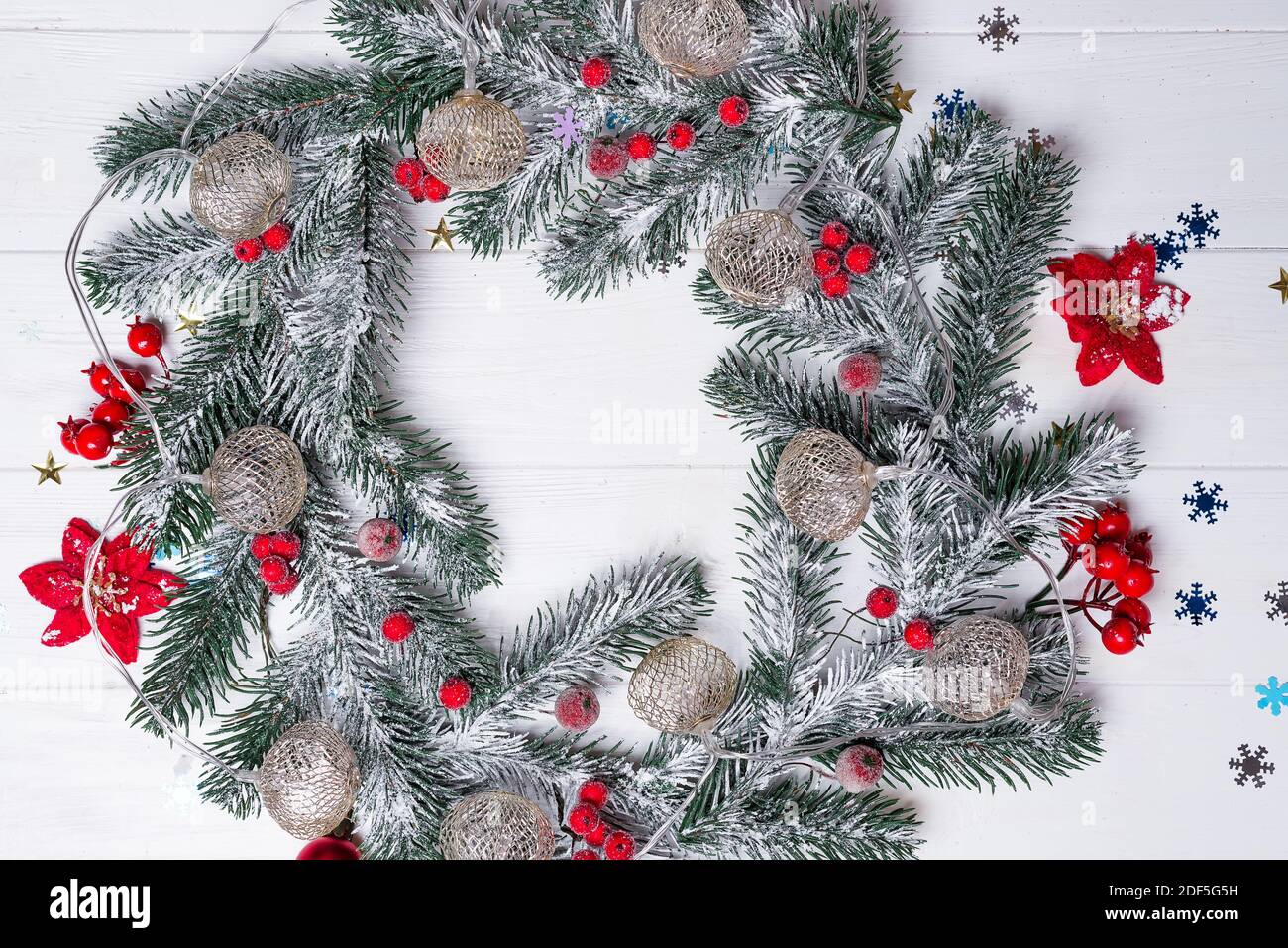 Christmas greeting card with decor and wreath of fir branches on a ...