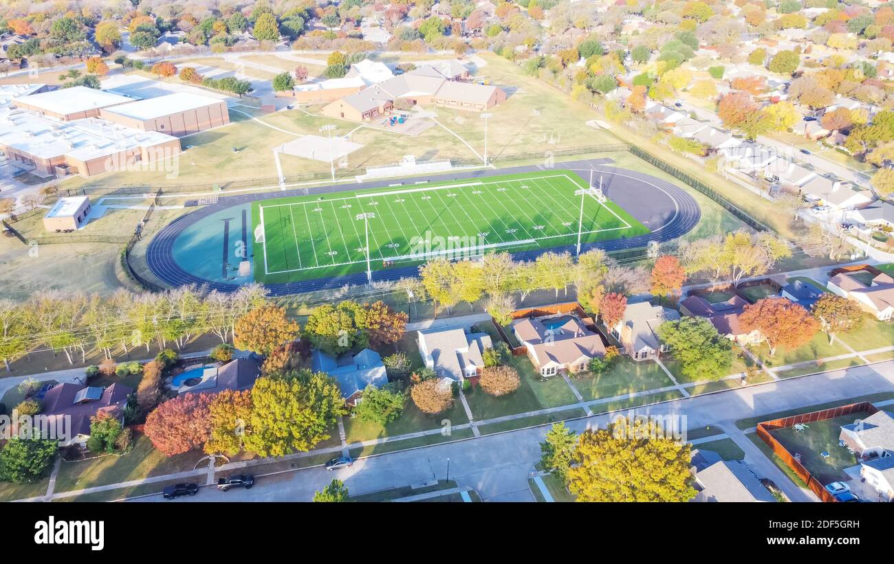 Aerial view middle school football field with running track, soccer