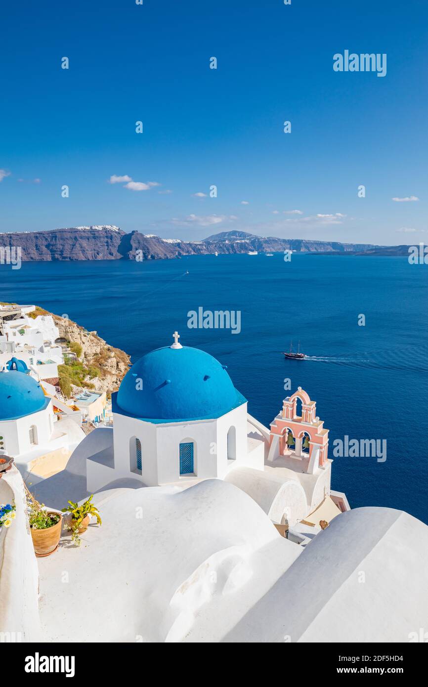 Beautiful Oia town on Santorini island, Greece. Traditional white architecture and greek orthodox churches with blue domes over Caldera, Aegean sea Stock Photo